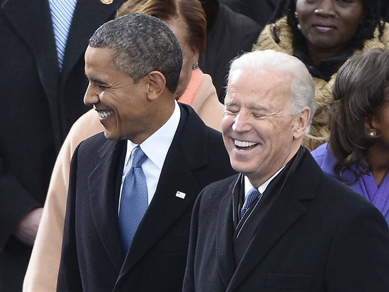 Биден shares a laugh with President Obama during the inauguration ceremony on the West Front of the US Capitol before Obama is ceremonially sworn in for a second term as the 44th President of the United States.