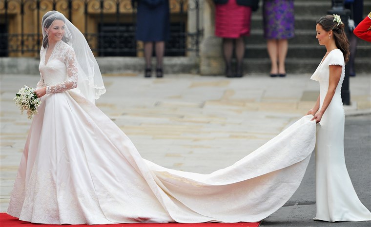 Kate Middleton is helped at her wedding by sister Pippa. 