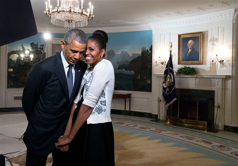 Michelle Obama snuggles against former president Barack Obama before a videotaping for the 2015 World Expo, in the Diplomatic Reception Room of the White House, March 27, 2015.