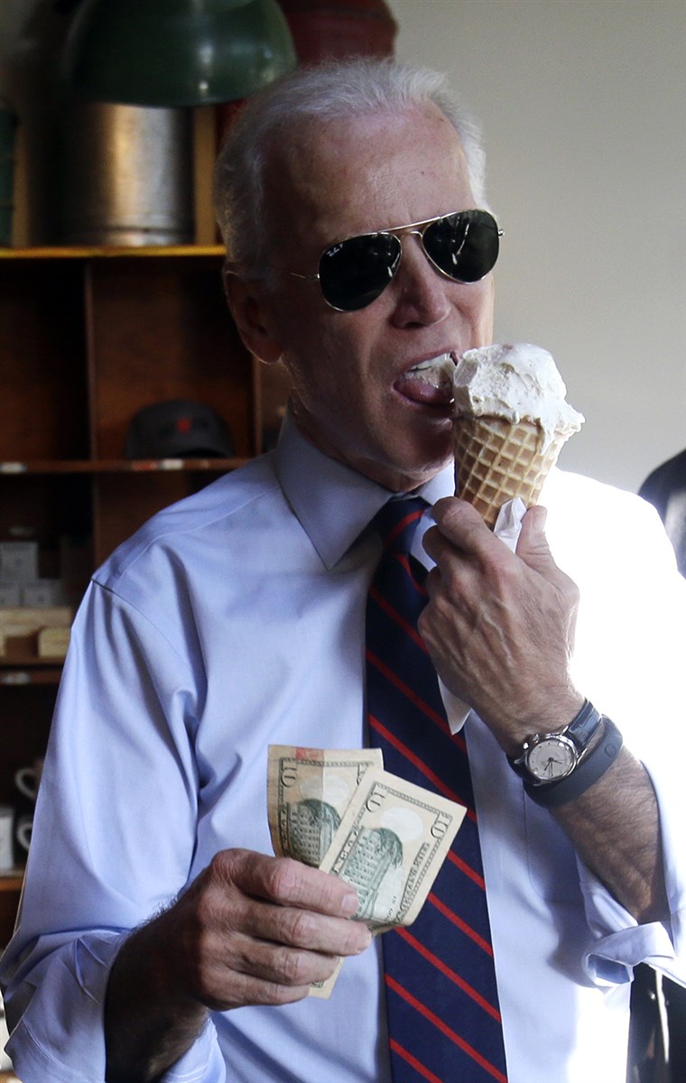 Вице President Joe Biden, right, gets ready to pay for an ice cream cone after a campaign rally for U.S. Sen. Jeff Merkley in Portland, Ore., Wednesd...