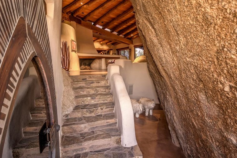Тхе 'boulder house' contains ancient rock carvings and is for sale