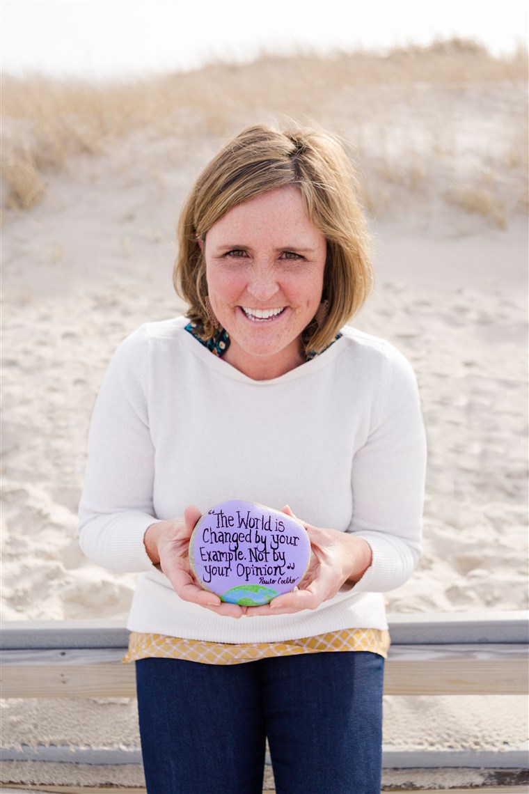 Megan Murphy, founder of the Kindness Rocks Project, with one of her painted rocks.