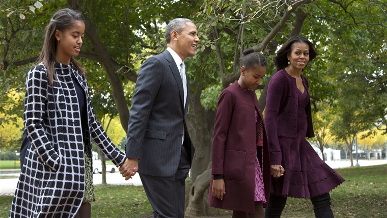 President Barack Obama, second from left, with first lady Michelle Obama, right, and their daughters Malia, left, and Sasha, walk on Lafayette Park ac...