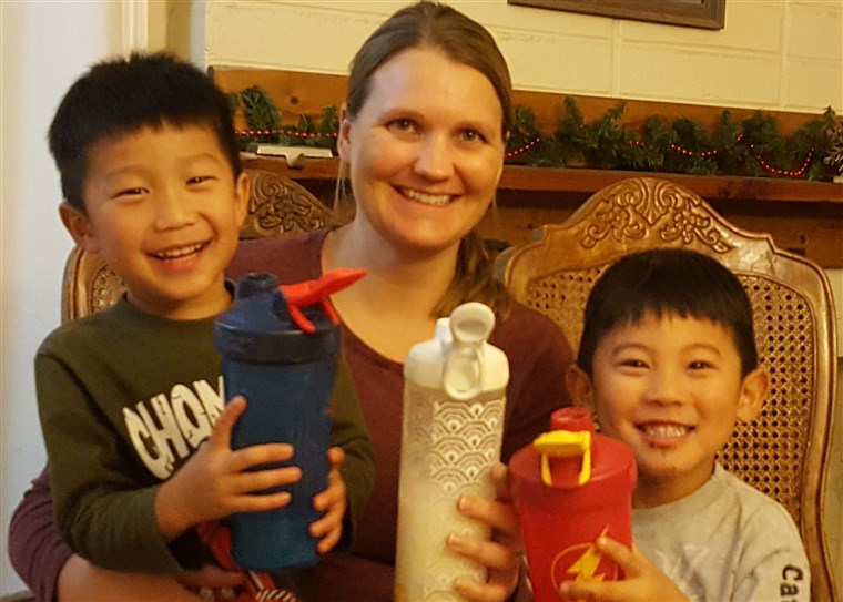 Smed drinking her special PKU formula with two of her sons.