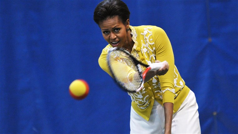 NE First Lady Michelle Obama plays tennis while attending a mini-Olympics event with local school children at American University's Bender Arena March...