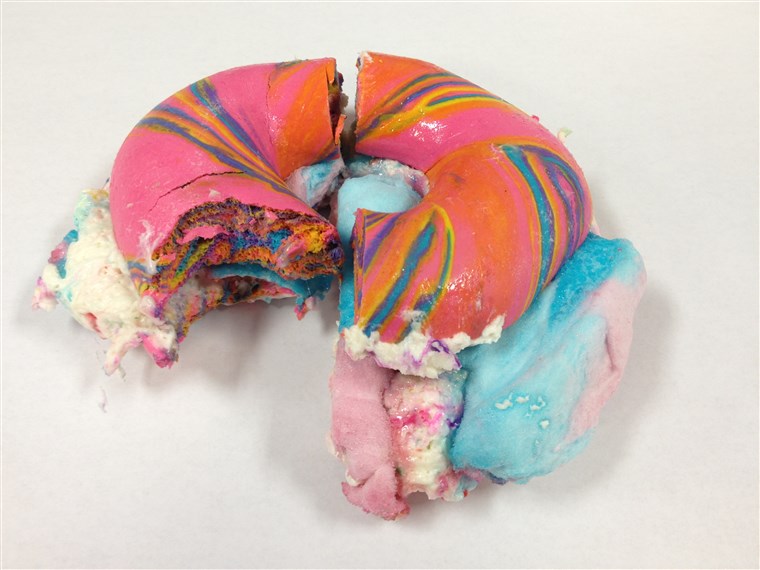 Primul bite of Rainbow Bagel Stuffed with Funfetti Cream Cheese and Cotton Candy from Brooklyn's The Bagel Store